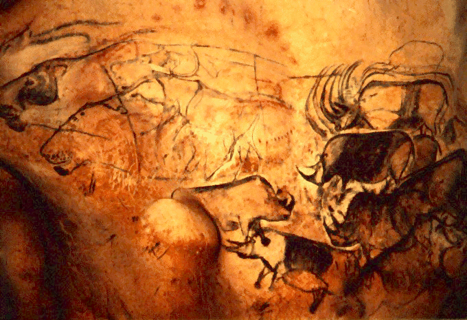Image Description: Cave Painting featuring several                 animals including rhinoceros.